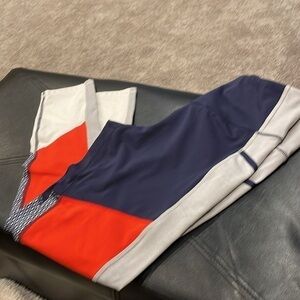 Champion athletic outfit in orange, white and navy blue. Top S, bottom L